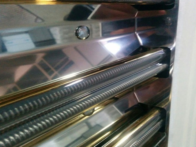 Close-up of infrared heating tubes and reflector assembly