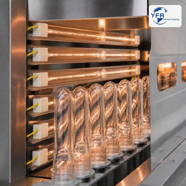Infrared heating lamps preheating PET preforms in a blow molding machine
