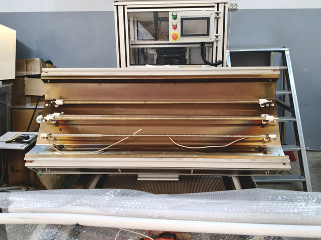 Infrared heating lamps installed inside industrial machine heating module
